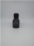 black perfume bottle in glass cap